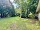 Expansive backyard with lush lawn and mature trees offering a private and serene outdoor space at 524 Kell Pl, Charleston, SC 29412