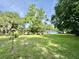 Back yard with a view of the exterior of the house and trees at 524 Kell Pl, Charleston, SC 29412