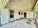 View of the covered carport featuring a textured ceiling, multiple doors, and an exterior wall at 524 Kell Pl, Charleston, SC 29412