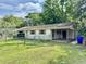 Side view of single-story home featuring a covered carport and a mix of grass and partial fencing at 524 Kell Pl, Charleston, SC 29412