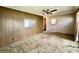 A living room featuring dated wood paneling, torn carpeting, and an open doorway to another room at 524 Kell Pl, Charleston, SC 29412