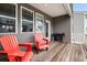 Cozy back porch with red Adirondack chairs and a grill for outdoor entertaining at 582 Mclernon Trce, Johns Island, SC 29455