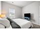 Comfortable bedroom with a TV, blue accents, and a large window at 582 Mclernon Trce, Johns Island, SC 29455
