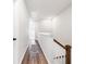 Bright hallway with hardwood floors, leading to bedrooms, and featuring a stairwell at 582 Mclernon Trce, Johns Island, SC 29455