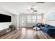 Spacious living room features hardwood floors, natural light, and a comfortable blue sofa at 582 Mclernon Trce, Johns Island, SC 29455