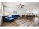 Bright living room boasts hardwood floors, ceiling fan, and flows into the dining area at 582 Mclernon Trce, Johns Island, SC 29455