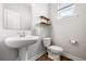 Charming powder room features a pedestal sink, toilet, and floating shelves at 582 Mclernon Trce, Johns Island, SC 29455