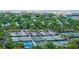 Aerial view of a beachfront community with tennis courts, parking, and lush greenery at 5847 Back Bay Dr, Isle of Palms, SC 29451