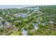 Scenic aerial view of golf community with homes, golf course, and winding lagoons near the beach at 5847 Back Bay Dr, Isle of Palms, SC 29451