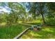 Scenic backyard with lush lawn and walkway and greenery, offering a peaceful outdoor space at 5847 Back Bay Dr, Isle of Palms, SC 29451