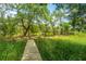 Scenic backyard with a wooden walkway and greenery, offering a peaceful outdoor space at 5847 Back Bay Dr, Isle of Palms, SC 29451