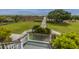 Beautiful backyard with a wooden walkway leading to the beach, featuring mature landscaping at 5847 Back Bay Dr, Isle of Palms, SC 29451