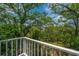 Balcony with lush trees view and white railing providing a serene outdoor retreat at 5847 Back Bay Dr, Isle of Palms, SC 29451