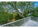 Balcony with lush trees view and white railing providing a serene outdoor retreat at 5847 Back Bay Dr, Isle of Palms, SC 29451