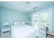Bright bedroom features a plush bed, ceiling fan and private access to a balcony, providing a serene retreat at 5847 Back Bay Dr, Isle of Palms, SC 29451