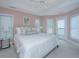 Bright bedroom boasts a ceiling fan, neutral walls, and a door that leads to a private balcony at 5847 Back Bay Dr, Isle of Palms, SC 29451