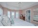 Bright bedroom boasts a ceiling fan, neutral walls, and a door that leads to a private balcony at 5847 Back Bay Dr, Isle of Palms, SC 29451
