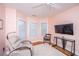 Bedroom features natural light, a ceiling fan, a neutral color palette, and hardwood floors at 5847 Back Bay Dr, Isle of Palms, SC 29451