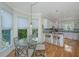 Cozy dining area adjacent to the kitchen, featuring a glass table and ample natural light at 5847 Back Bay Dr, Isle of Palms, SC 29451