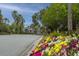 The community entrance features colorful flower beds and palm trees along the roadside at 5847 Back Bay Dr, Isle of Palms, SC 29451