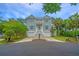 Charming grey two-story home with blue shutters and well-maintained landscaping at 5847 Back Bay Dr, Isle of Palms, SC 29451