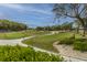Scenic view of the golf course featuring lush green fairways, mature trees, and sand traps at 5847 Back Bay Dr, Isle of Palms, SC 29451