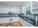 Charming kitchen with stainless steel appliances, granite countertops, and hardwood flooring at 5847 Back Bay Dr, Isle of Palms, SC 29451