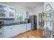 Well-equipped kitchen showcasing ample counter space, cabinetry, stainless steel fridge, and open dining area at 5847 Back Bay Dr, Isle of Palms, SC 29451