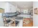 Modern kitchen featuring white cabinetry, sleek black countertops, and stainless steel appliances at 5847 Back Bay Dr, Isle of Palms, SC 29451