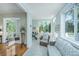 Bright sunroom with large windows offering serene views and comfortable seating arrangement at 5847 Back Bay Dr, Isle of Palms, SC 29451