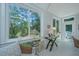 Inviting sunroom with scenic outdoor views, featuring a writing desk and comfortable wicker chair at 5847 Back Bay Dr, Isle of Palms, SC 29451