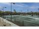 Well-maintained tennis courts with lighting and viewing stands surrounded by palm trees at 5847 Back Bay Dr, Isle of Palms, SC 29451