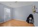 Cozy bedroom with wood-look flooring, a large window with curtains, and a neutral color palette at 6231 Rolling Fork Rd # 1201-A, North Charleston, SC 29406