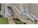 Beige home with wooden stairs leading up to the front door and a welcome sign at 6231 Rolling Fork Rd # 1201-A, North Charleston, SC 29406