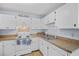 Functional kitchen featuring white cabinets, laminate countertops, and modern appliances at 6231 Rolling Fork Rd # 1201-A, North Charleston, SC 29406