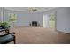 Bright living room with a cozy fireplace, large windows, and neutral carpet at 6231 Rolling Fork Rd # 1201-A, North Charleston, SC 29406