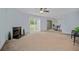 Spacious living room with a fireplace, sliding glass doors, and neutral carpet at 6231 Rolling Fork Rd # 1201-A, North Charleston, SC 29406