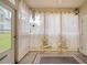Screened porch featuring decorative white curtains and yellow chairs at 6231 Rolling Fork Rd # 1201-A, North Charleston, SC 29406