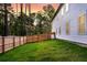 View of a large, green backyard with wooden privacy fence surrounding a home with vinyl siding at 69 Red Bluff St, Summerville, SC 29483
