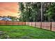 Spacious fenced-in backyard with lush green grass and mature trees, offering privacy at 69 Red Bluff St, Summerville, SC 29483