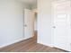 Minimalist bedroom with open doorway and clean lines and vinyl plank flooring at 69 Red Bluff St, Summerville, SC 29483