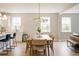 Bright dining area with modern lighting, hardwood floors, and a view to the kitchen at 69 Red Bluff St, Summerville, SC 29483