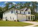 Charming two-story home with a welcoming front porch, manicured lawn, and attached garage at 69 Red Bluff St, Summerville, SC 29483