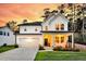 Charming two-story home with a welcoming front porch, manicured lawn, and attached garage at 69 Red Bluff St, Summerville, SC 29483