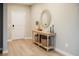 Stylish foyer with light wood floors, console table, decorative mirror, and elegant baskets at 69 Red Bluff St, Summerville, SC 29483