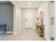 Bright foyer with light wood floors, console table, decorative mirror, and front door at 69 Red Bluff St, Summerville, SC 29483