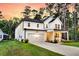 Charming two-story home with a well-manicured front yard, inviting porch, and a spacious two-car garage at 69 Red Bluff St, Summerville, SC 29483