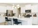 Modern kitchen features white cabinets, stainless steel appliances, an island, and bar stool seating at 69 Red Bluff St, Summerville, SC 29483