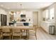 Bright kitchen with white cabinets, stainless steel appliances, hardwood floors and dining area at 69 Red Bluff St, Summerville, SC 29483