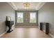 Elegant living room with hardwood floors, tray ceiling, large windows and stylish accent furniture at 69 Red Bluff St, Summerville, SC 29483
